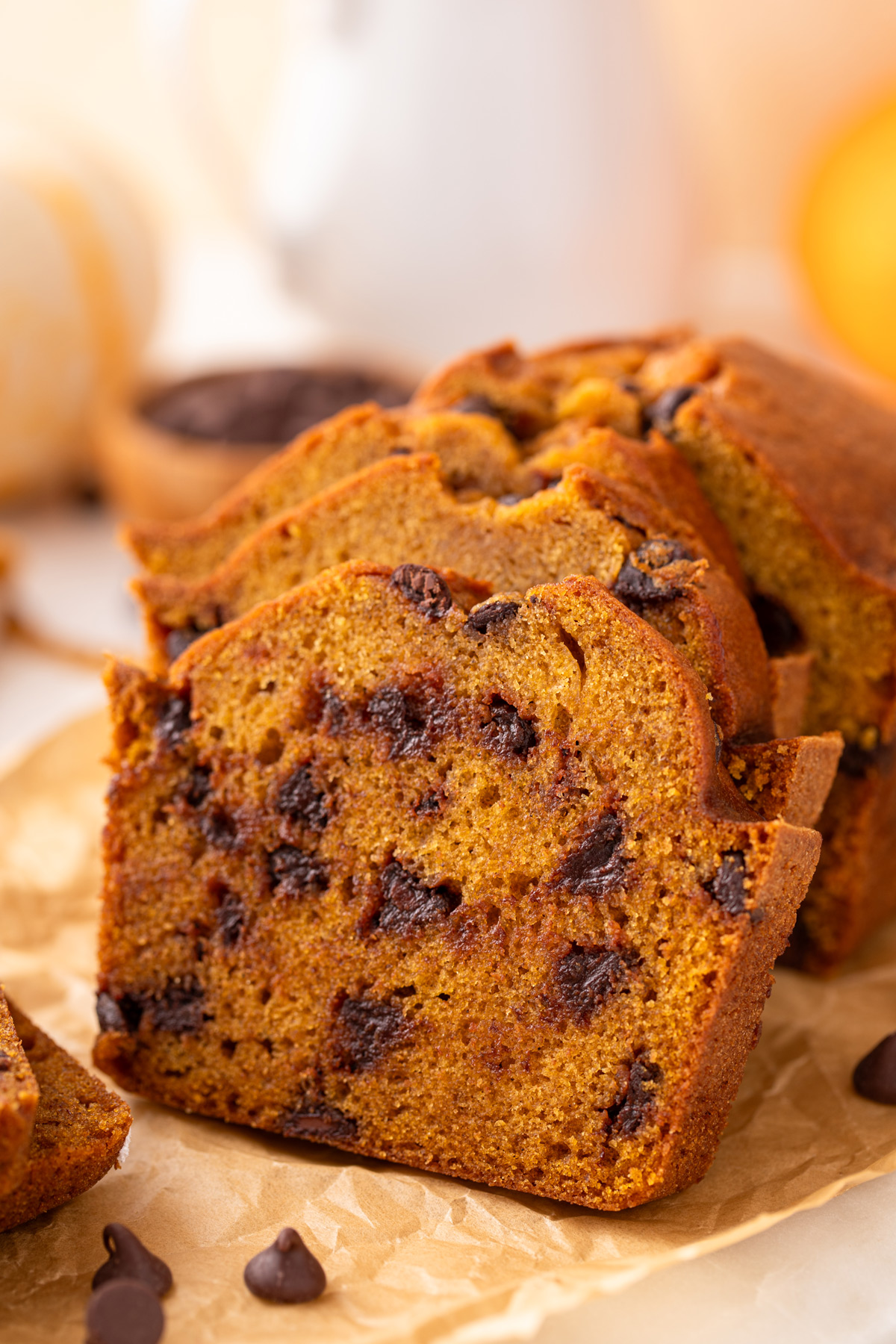 Close up of slices of chocolate chip pumpkin bread leaning against the rest of the loaf.