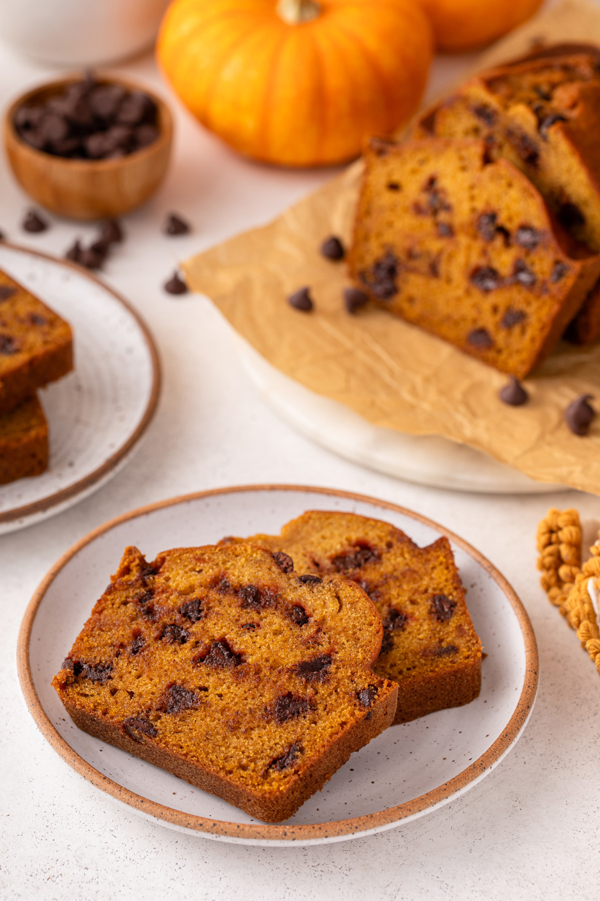 Two slices of chocolate chip pumpkin bread on a plate.