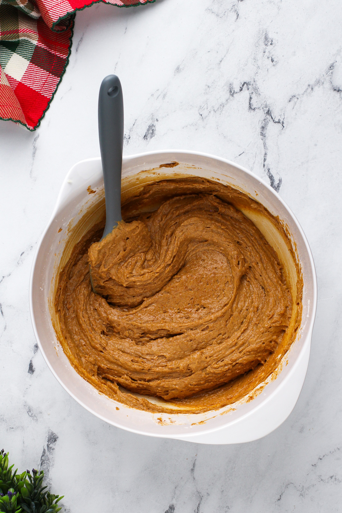 Cake batter base for gingerbread cake mixed in a white bowl.