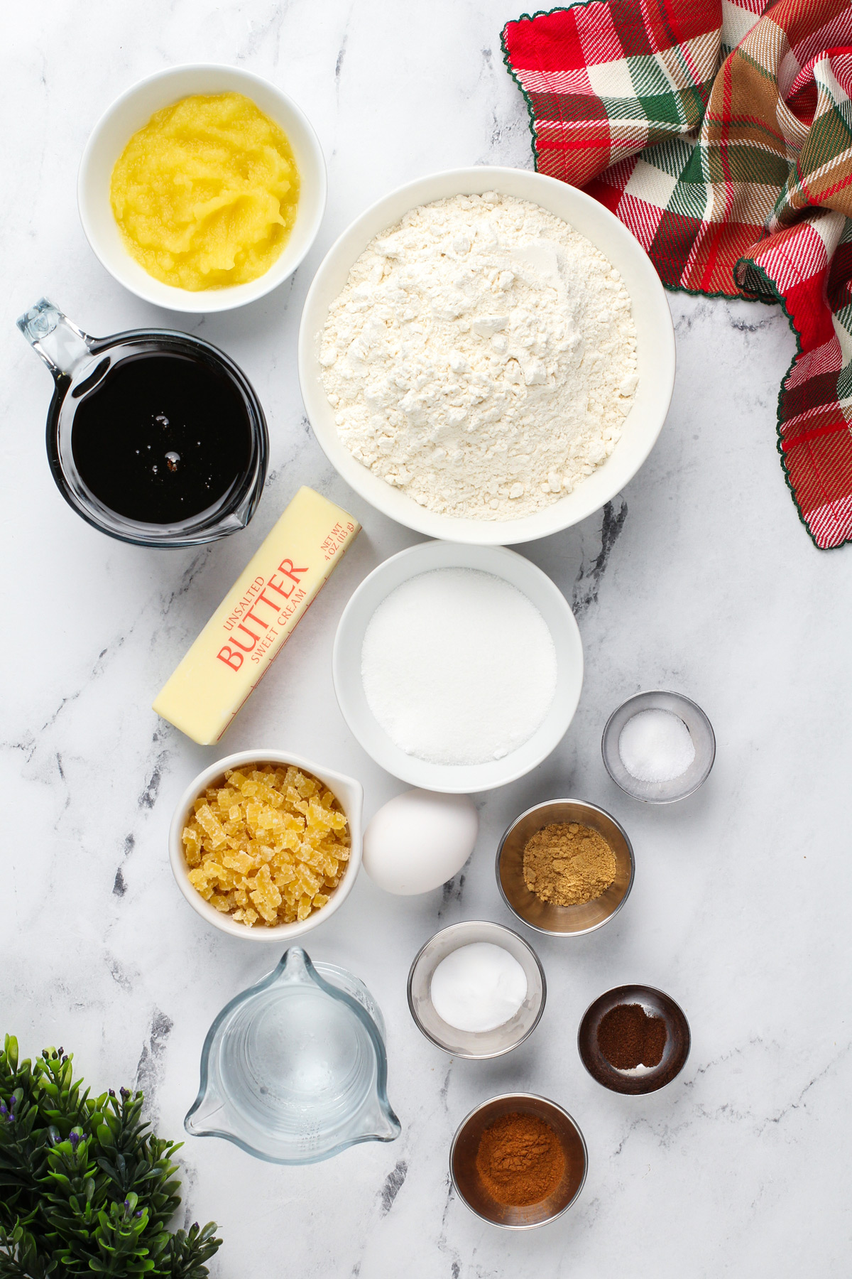 Gingerbread cake ingredients arranged on a marble countertop.