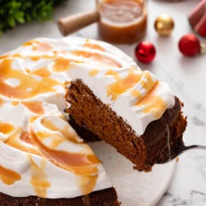 Slice of gingerbread cake being lifted up with a cake server.