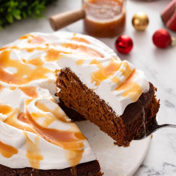 Slice of gingerbread cake being lifted up with a cake server.