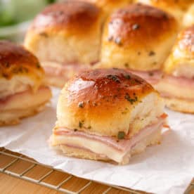 Close up of a hot ham and cheese slider.