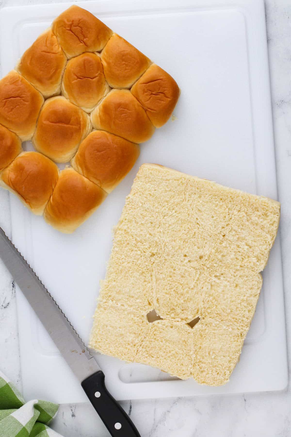 Hawaiian rolls sliced in half for making sliders.