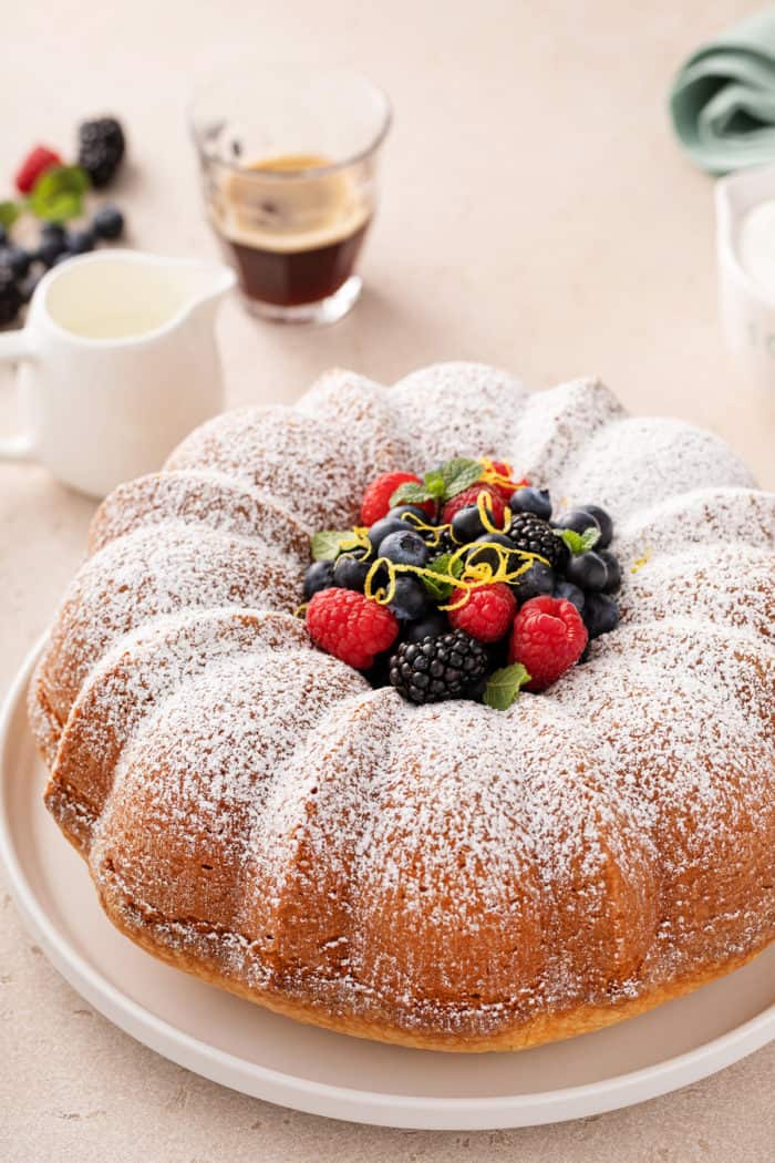 Cream cheese pound cake dusted with powdered sugar and topped with fresh berries.