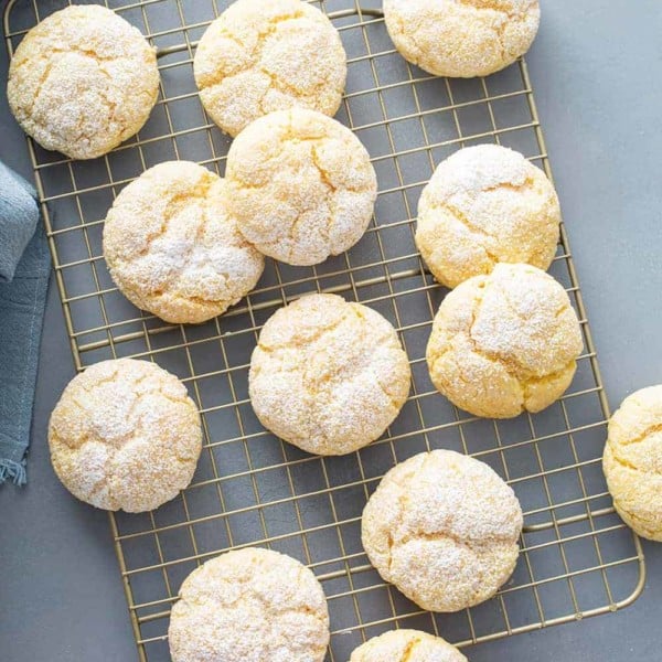 Baked gooey butter cookies arranged on a wire cooling rack