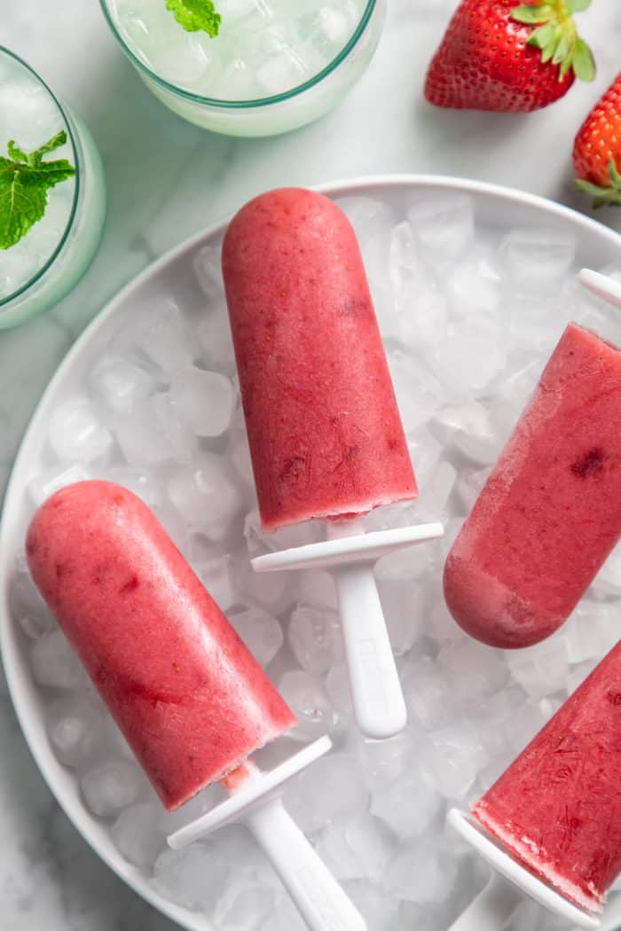https://www.mybakingaddiction.com/wp-content/uploads/2022/06/strawberry-popsicles-on-ice-700x1050.jpg