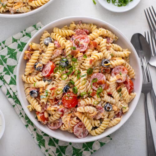 White bowl filled with bacon ranch pasta salad.