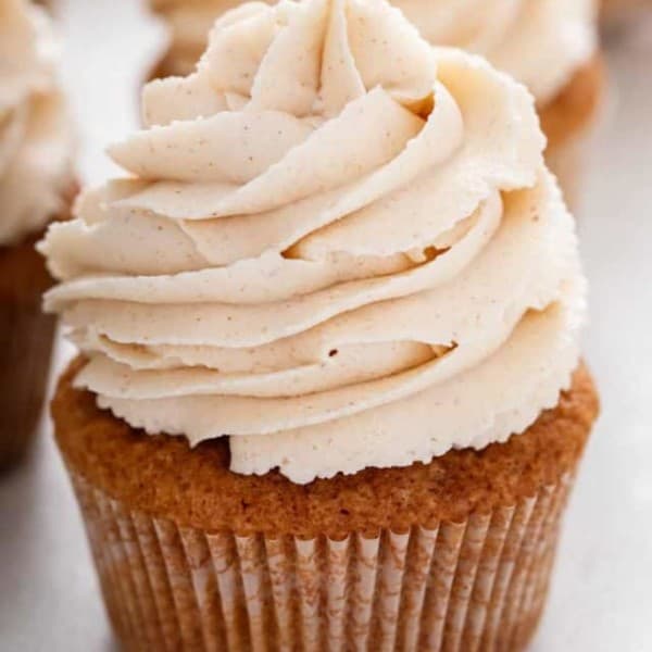 Close up of a spice cupcake topped with brown butter frosting.