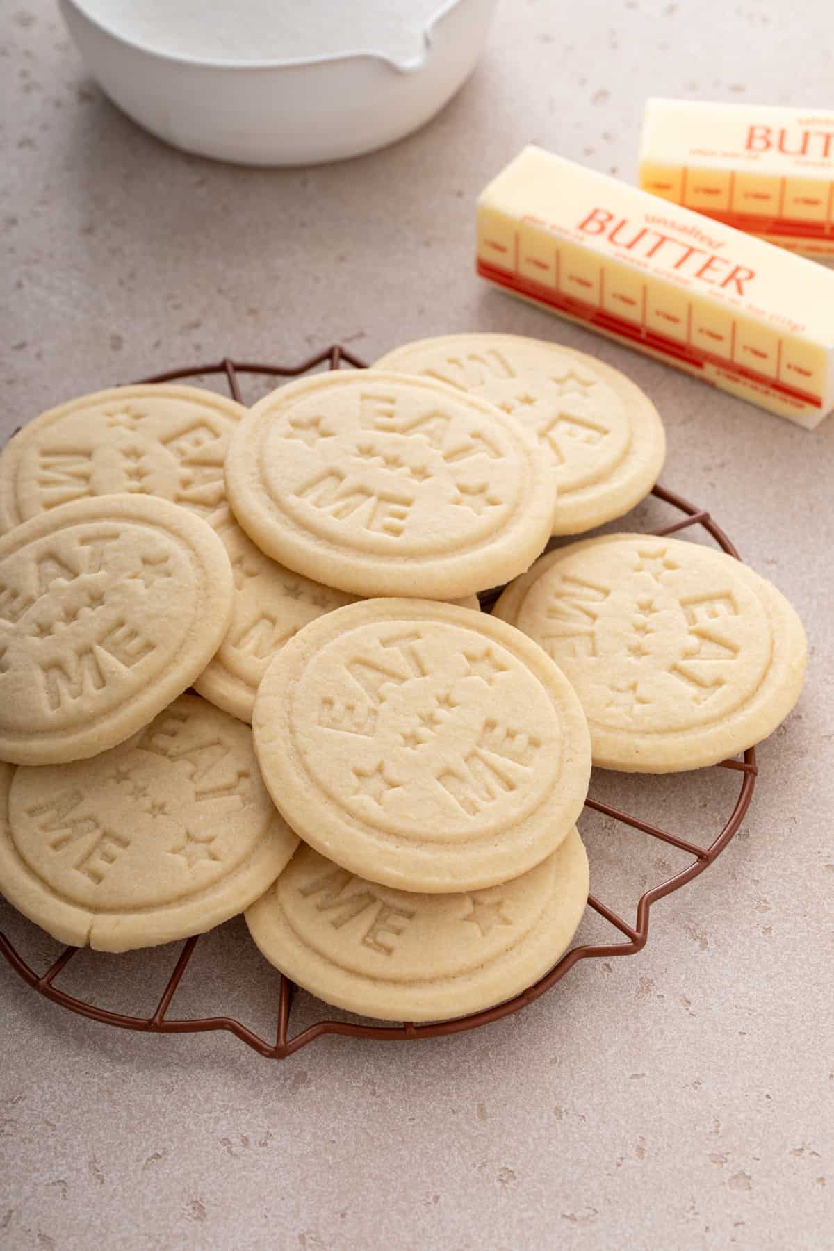 Stamped sugar cookies arranged on a metal rack.