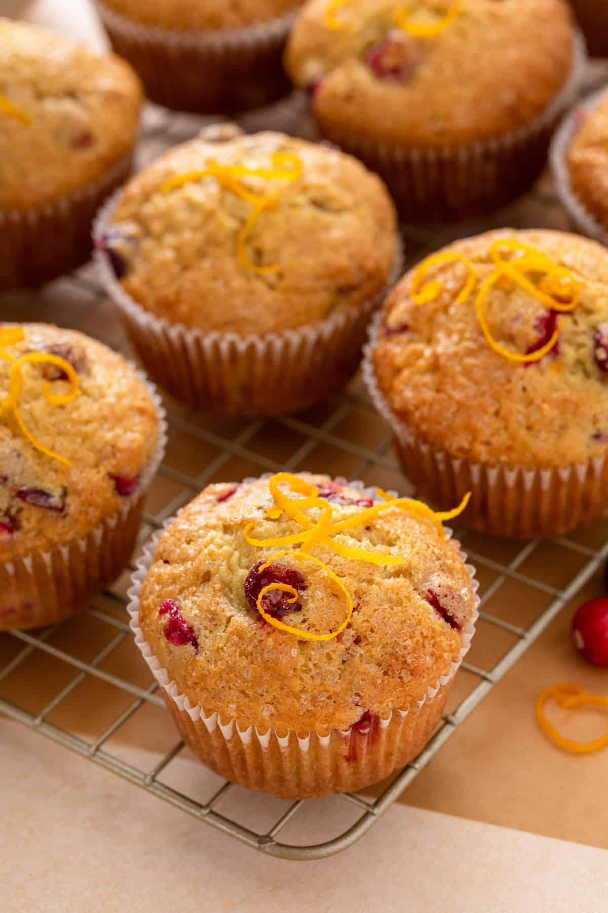 Close up of cranberry muffins on a wire cooling rack.