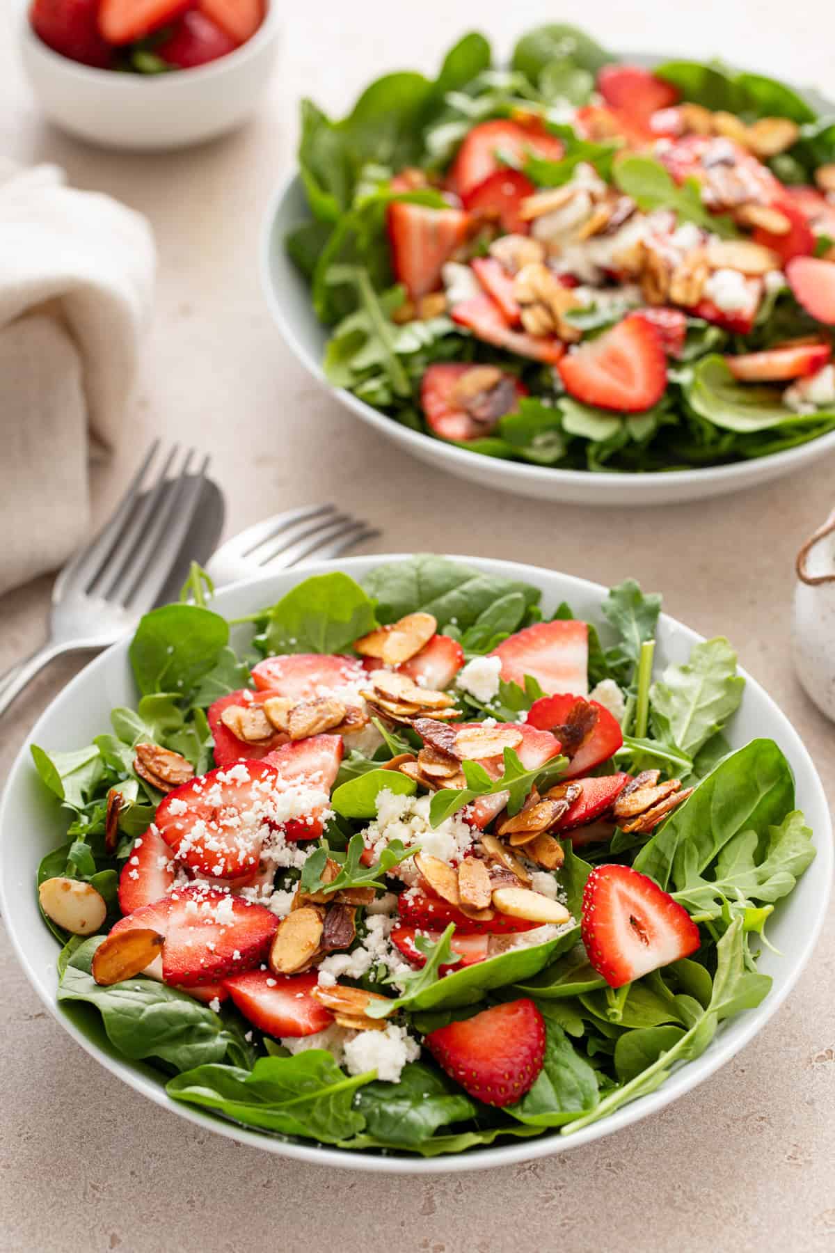 Two small bowls each holding a serving of fresh strawberry salad.
