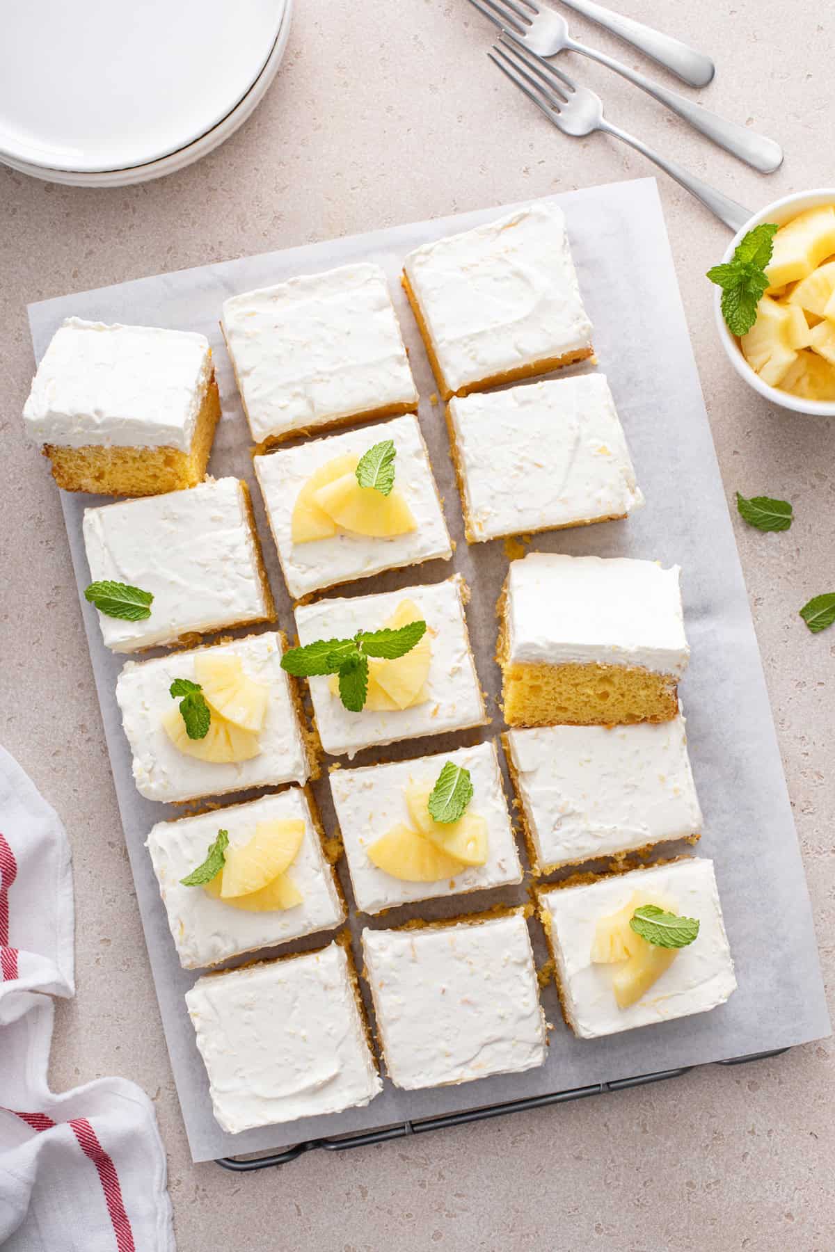 Overhead view of frosted easy pineapple cake cut into slices.