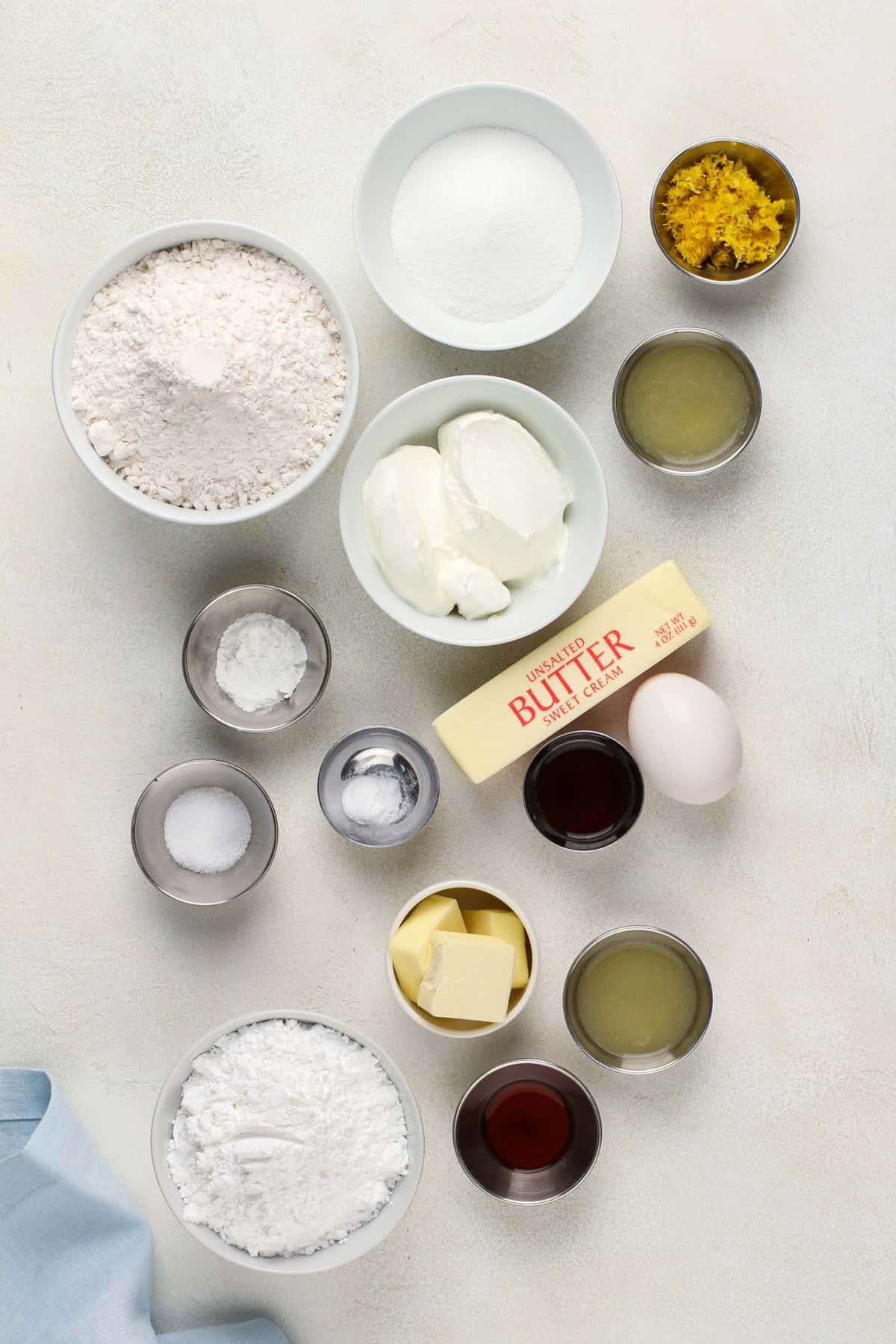 Ingredients for glazed lemon scones arranged on a countertop.