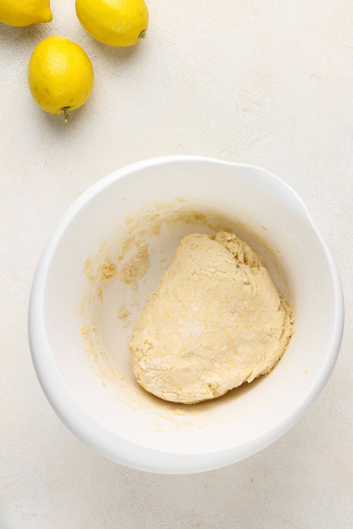 Lemon scone dough in a white mixing bowl.