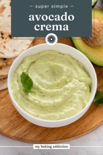 Close up image of avocado crema in a white bowl. Text overlay includes recipe name.