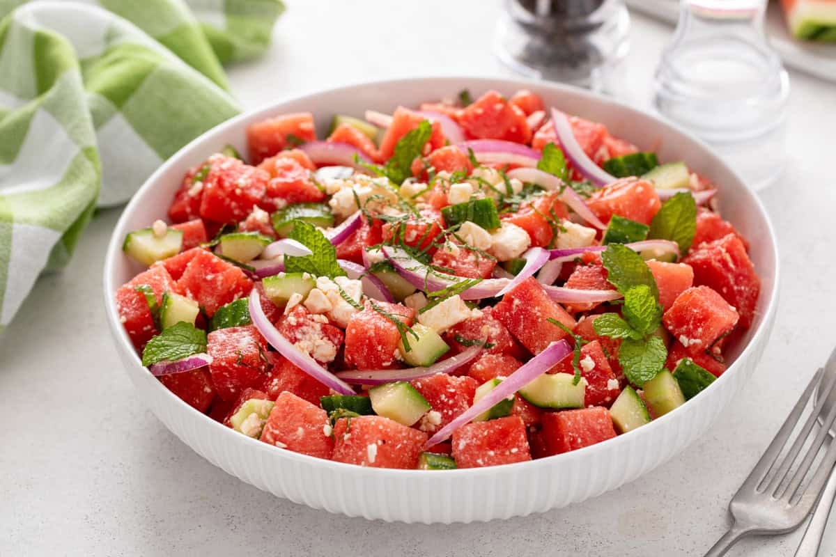 Watermelon feta salad in a serving bowl on a light-colored countertop.