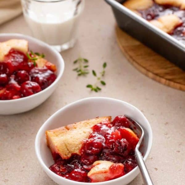 Two white bowls filled with servings of easy cherry cobbler.