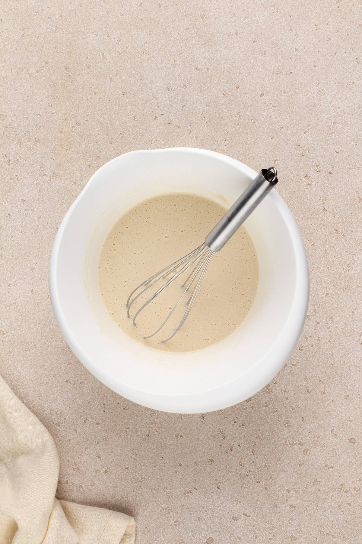 Batter for easy cherry cobbler in a white bowl.