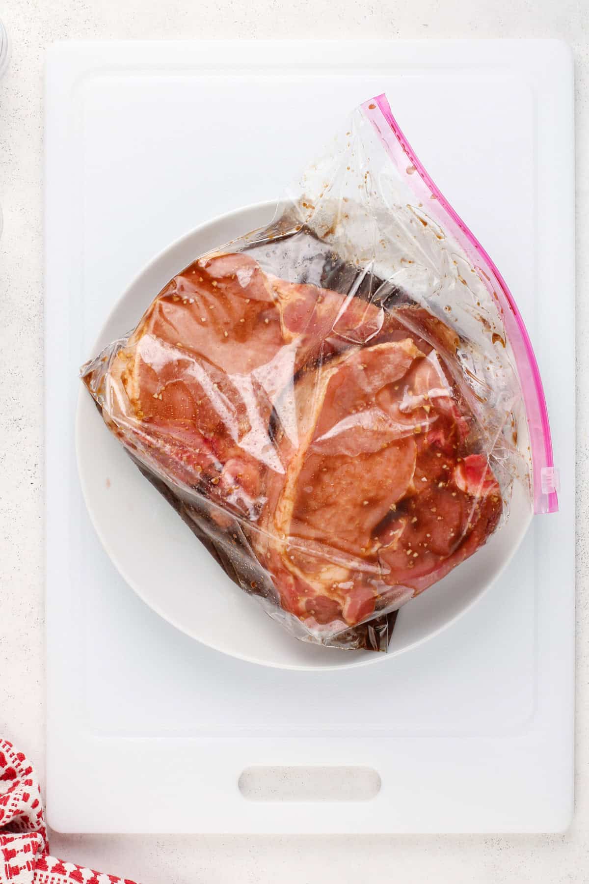 Pork chops and marinade in a zip-top bag.