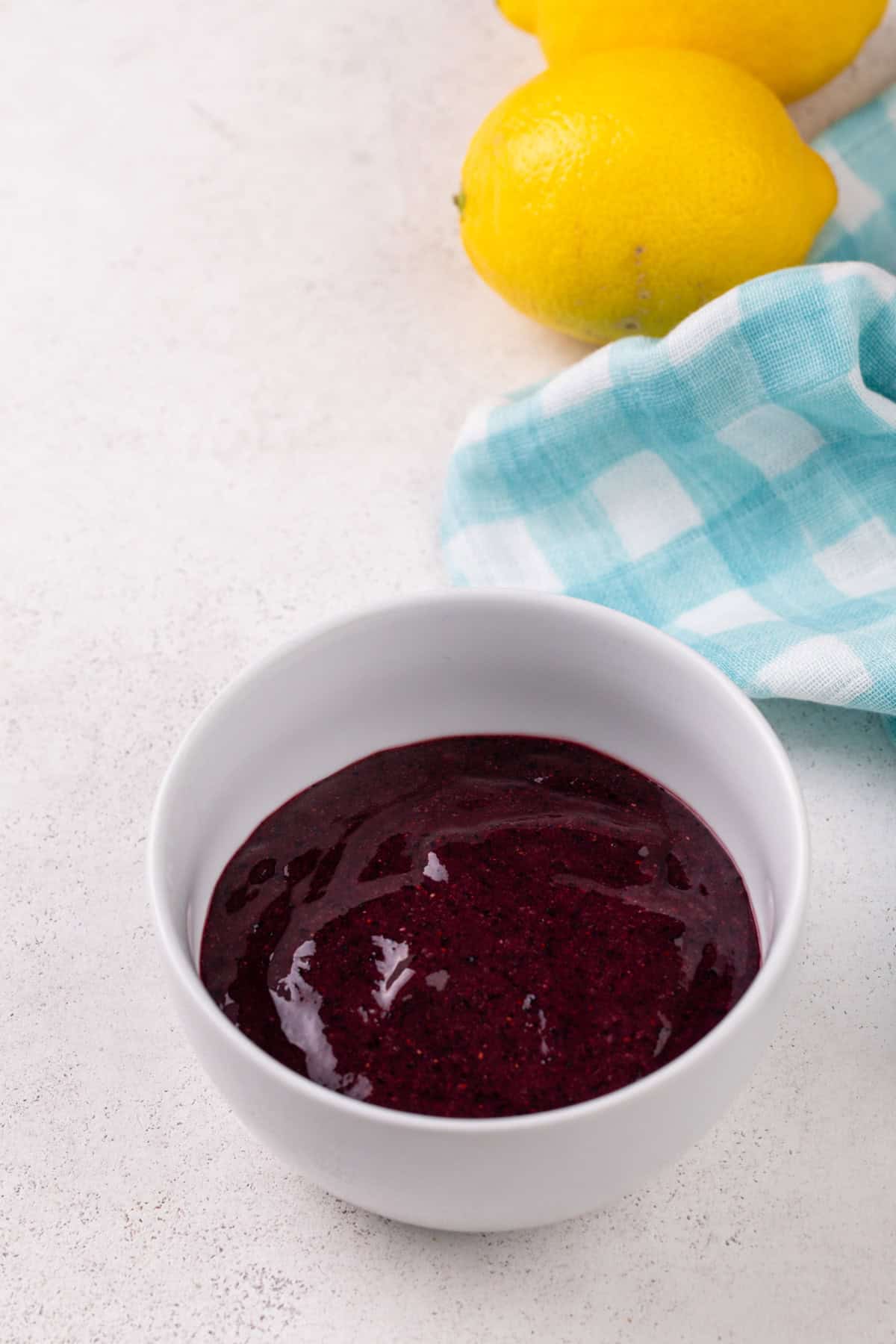 Strained blueberry puree in a white bowl.