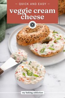 Bowl of veggie cream cheese in front of a plate with a bagel and veggie cream cheese on it. Text overlay includes recipe name.