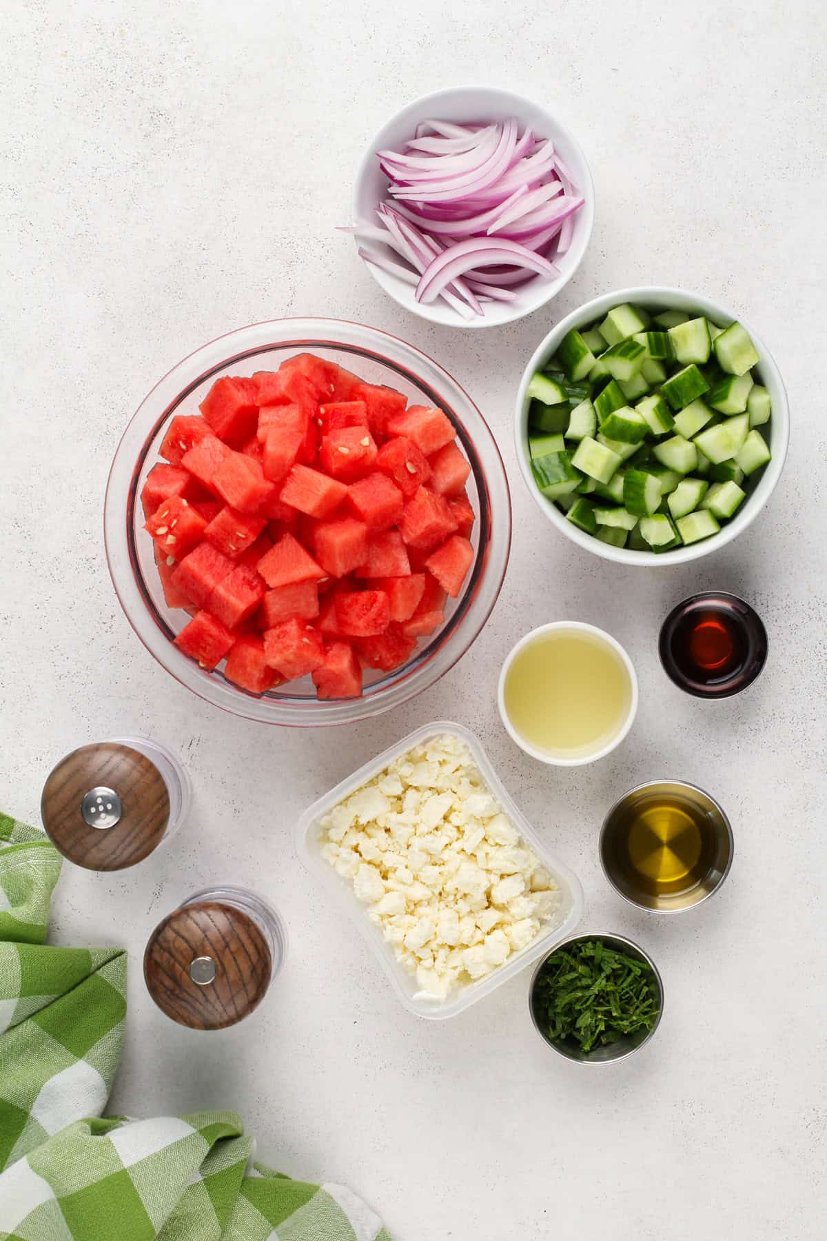 Ingredients for watermelon feta salad arranged on a countertop.
