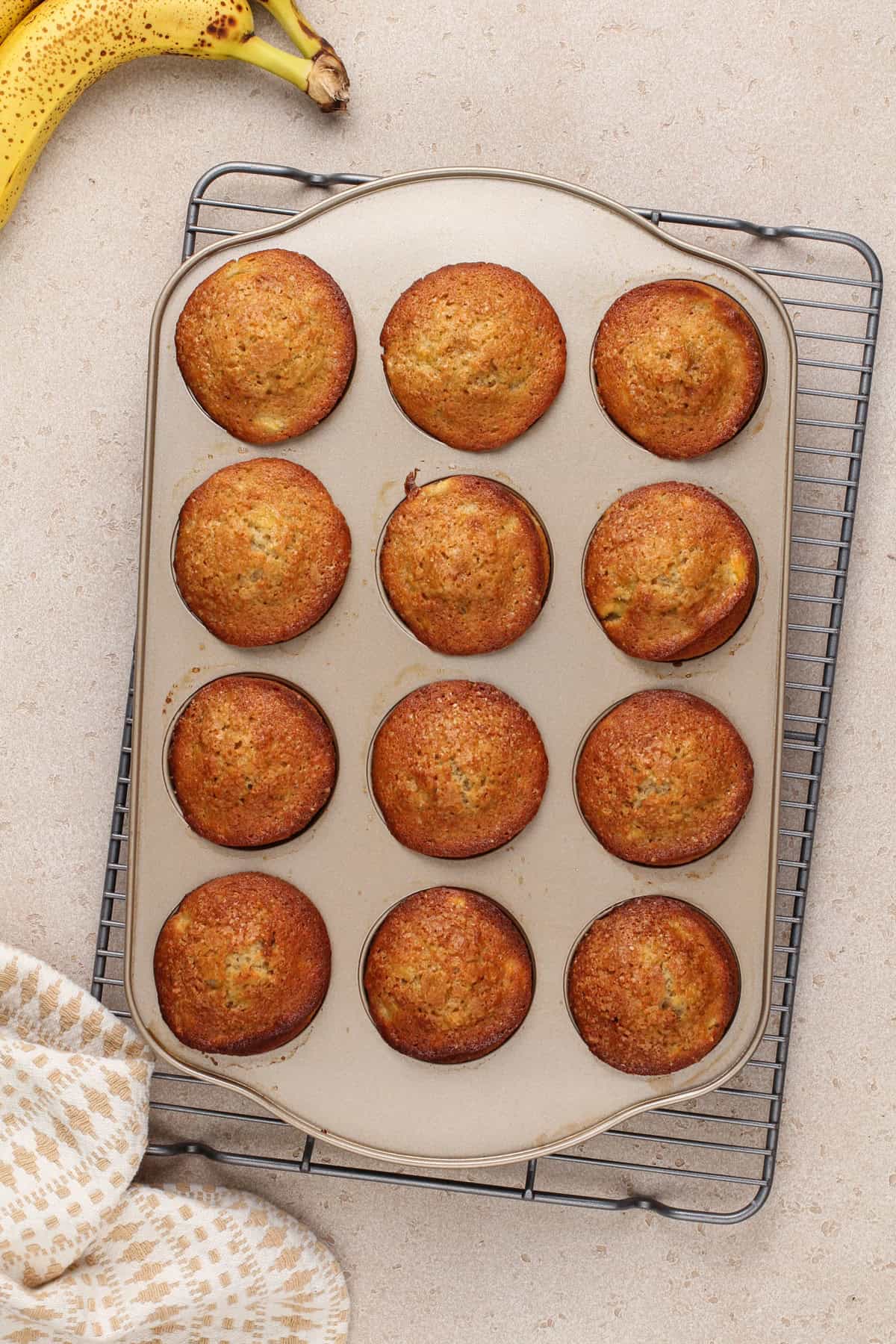 Baked banana bread muffins in a muffin tin.