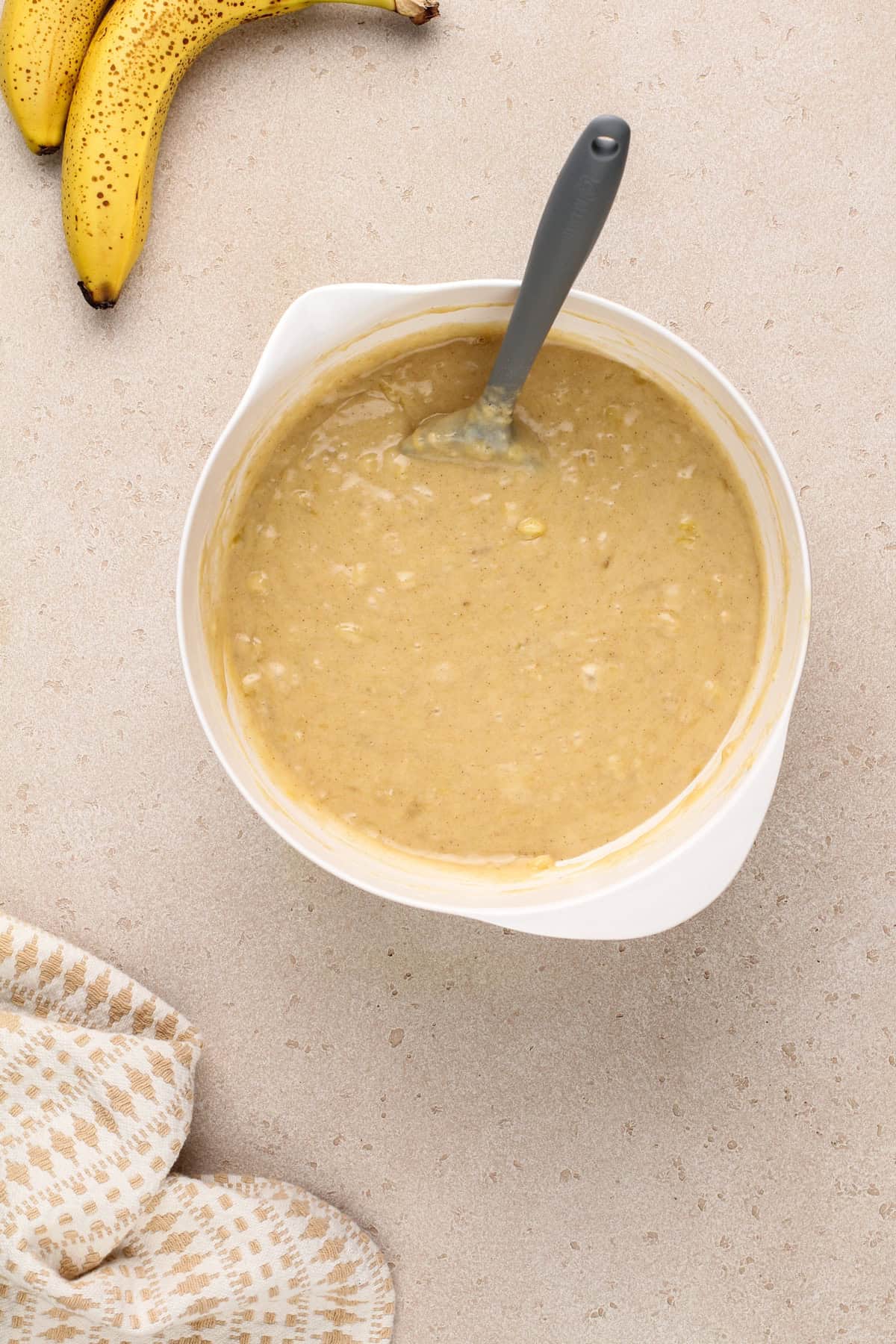 Banana bread muffin batter in a white bowl.