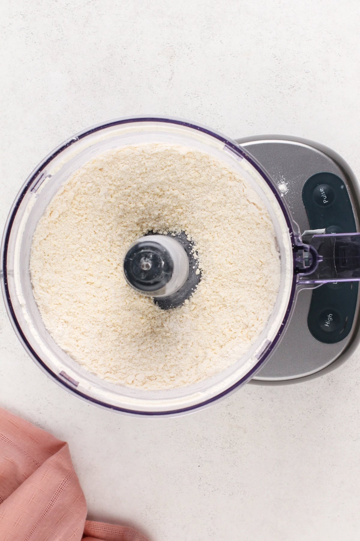 Butter, flour, sugar, and salt pulsed together in a food processor.