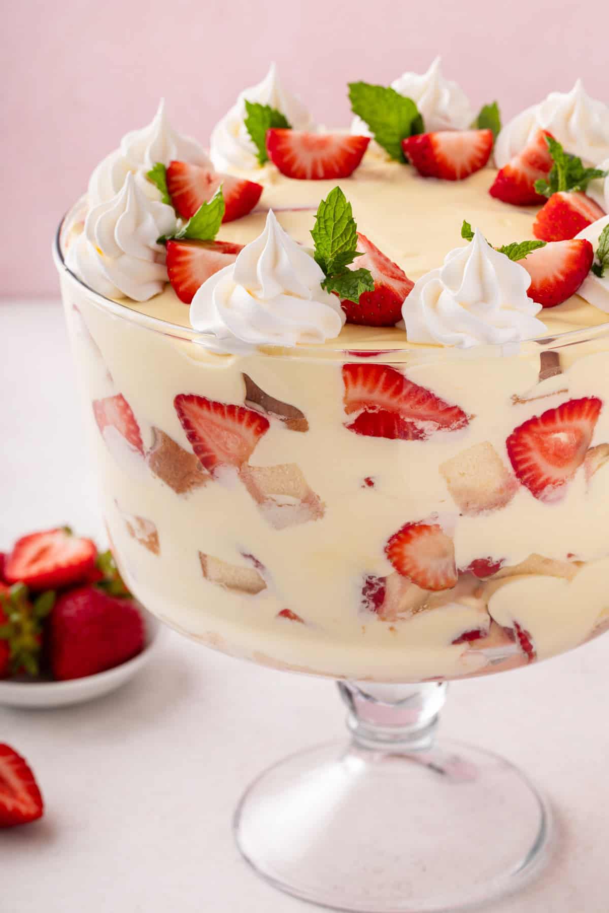 Close up of strawberry trifle layered in a trifle dish.