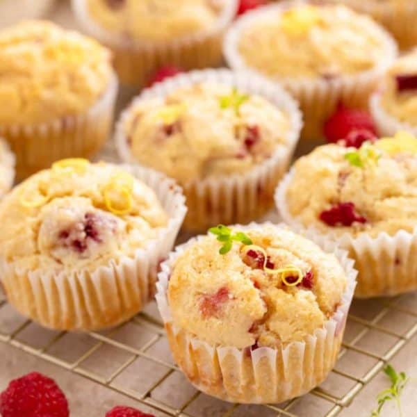 Lemon raspberry muffins arranged on a wire cooling rack.