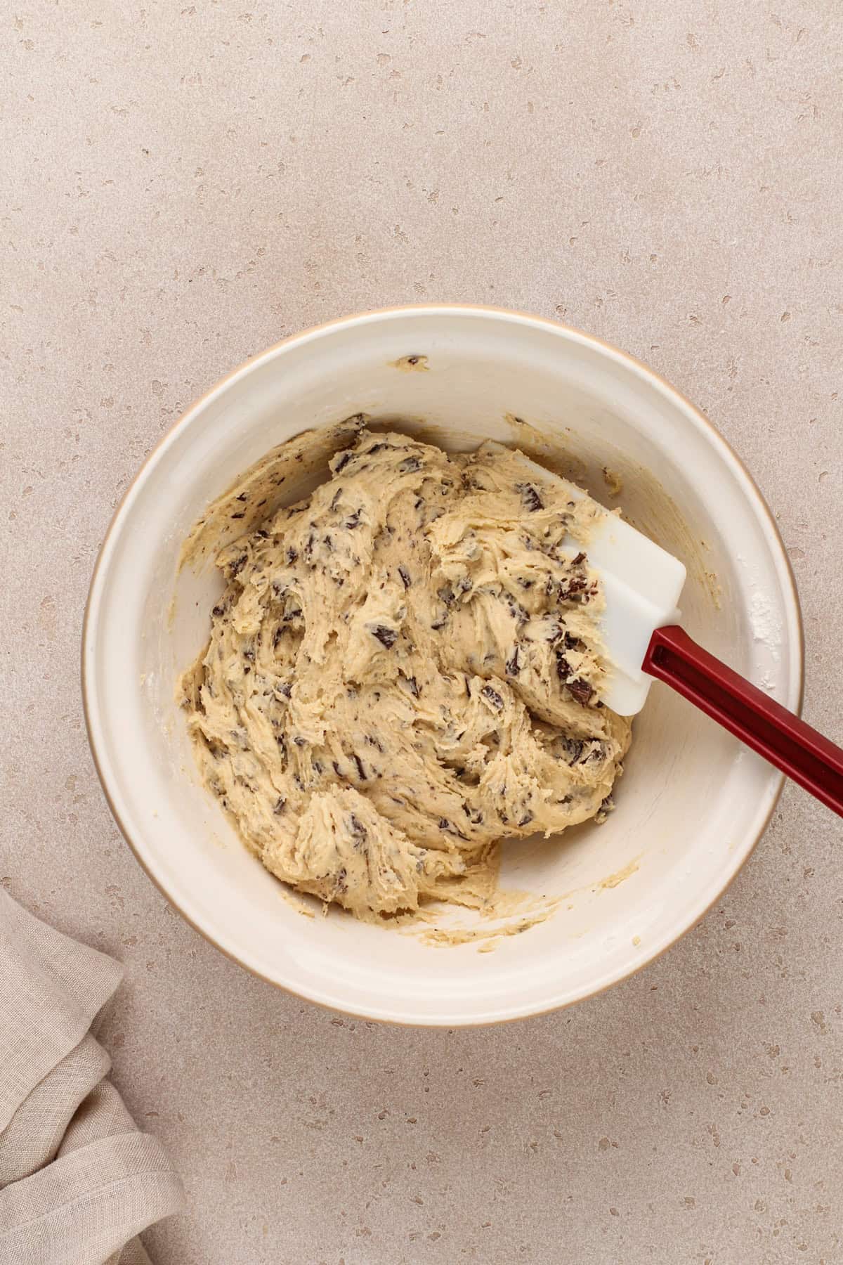 Easy chocolate chip cookie dough in a ceramic mixing bowl.