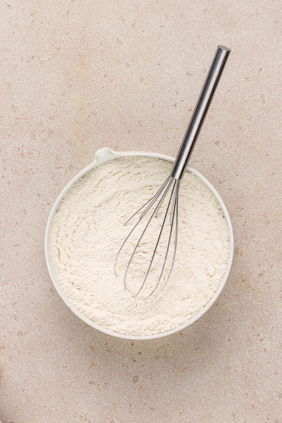 Dry ingredients for easy chocolate chip cookies whisked together in a bowl.