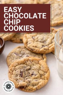 Easy chocolate chip cookies scattered on a piece of parchment paper next to a glass of milk. Text overlay includes recipe name.