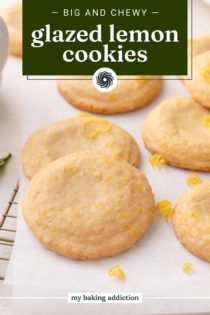 Glazed lemon cookies scattered on a piece of parchment paper. Text overlay includes recipe name.