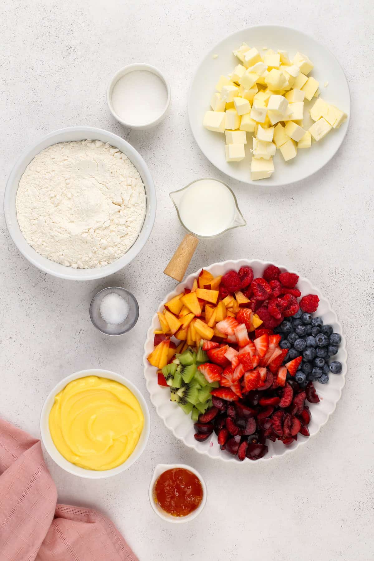 Ingredients for mini fruit tarts arranged on a counterop.