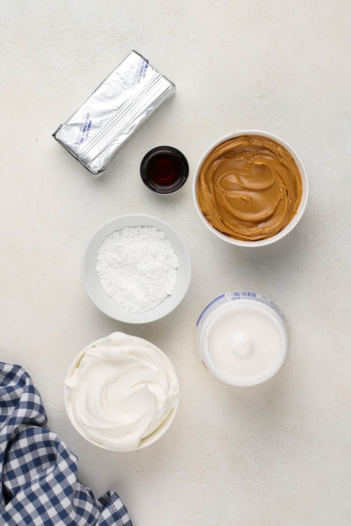 Ingredients for peanut butter dip arranged on a gray countertop.