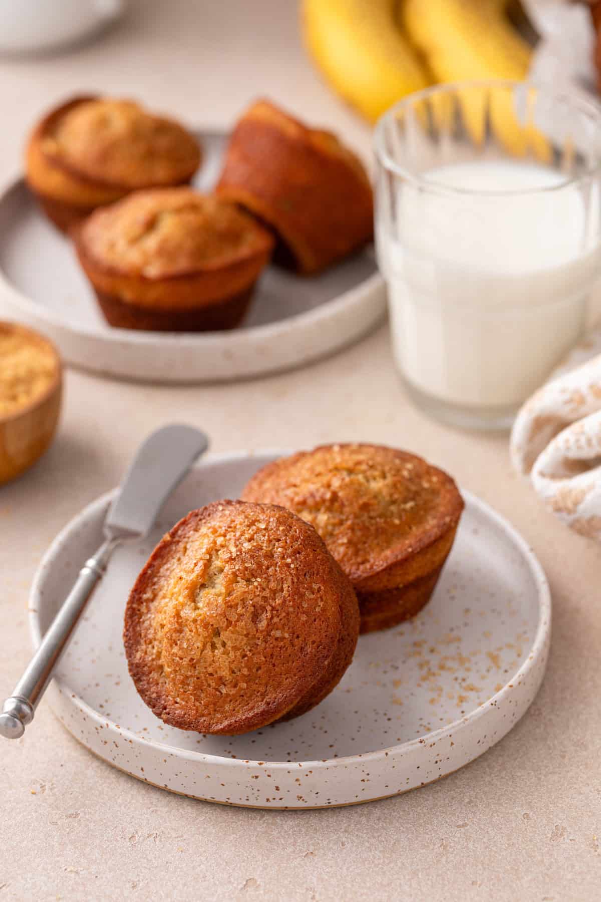 Two banana bread muffins arranged on a plate.