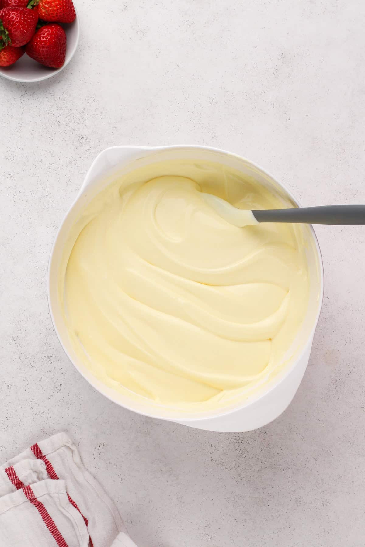 Vanilla pudding combined with whipped cream in a white bowl.