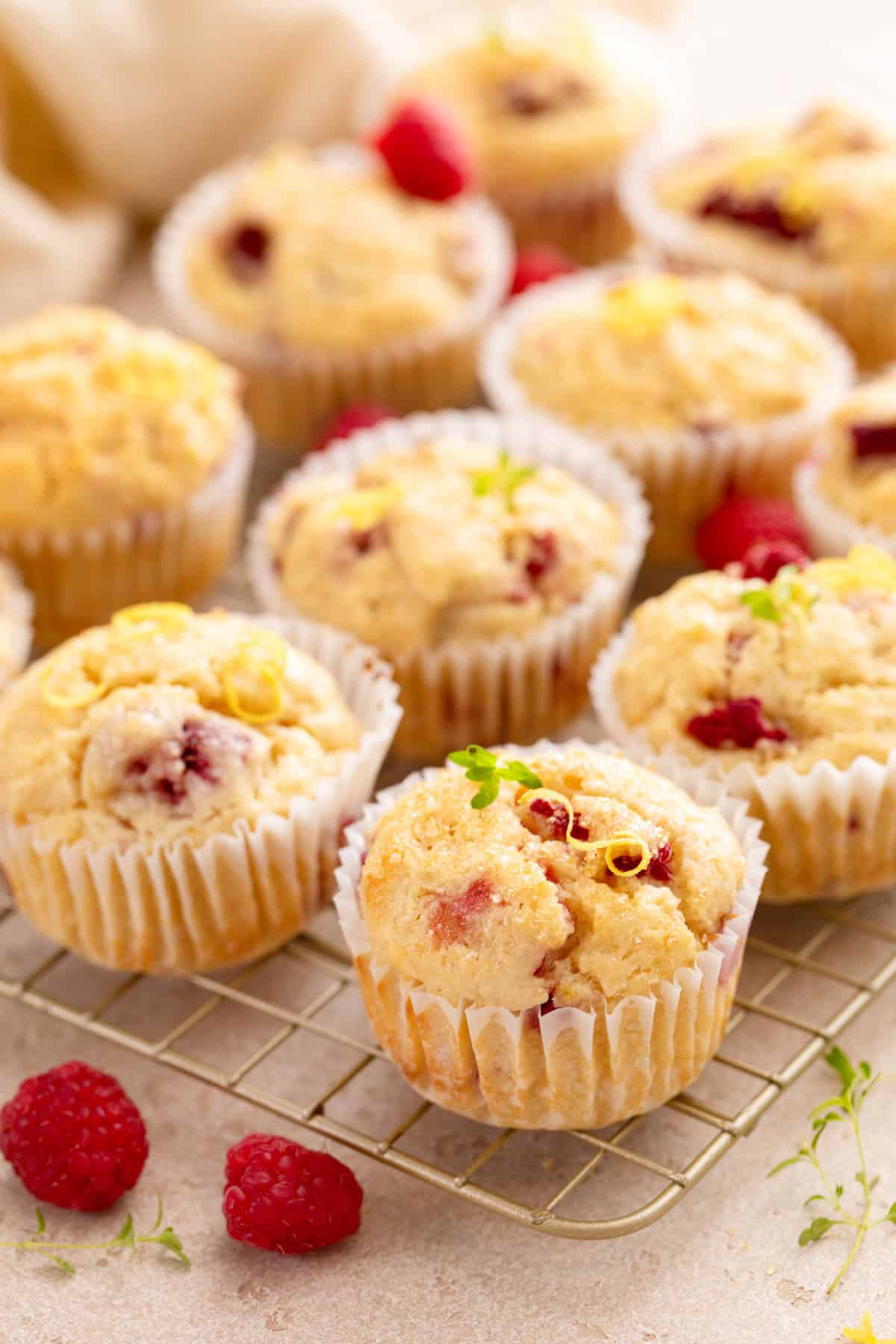 Lemon raspberry muffins arranged on a wire cooling rack.