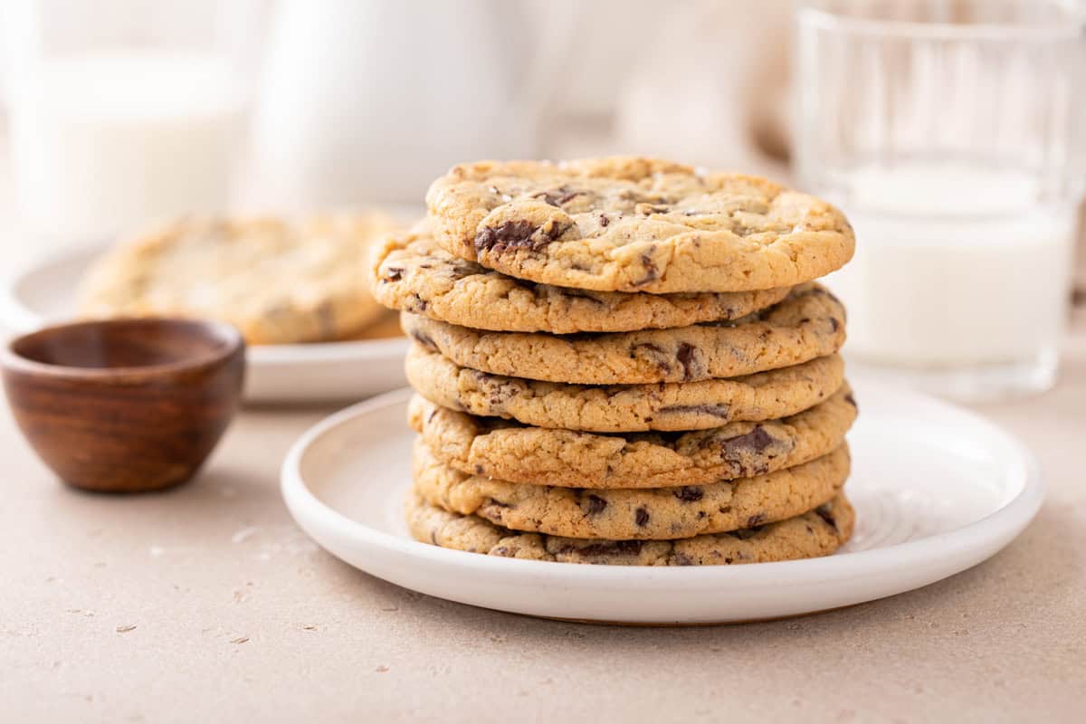 Several easy chocolate chip cookies stacked on a white plate.