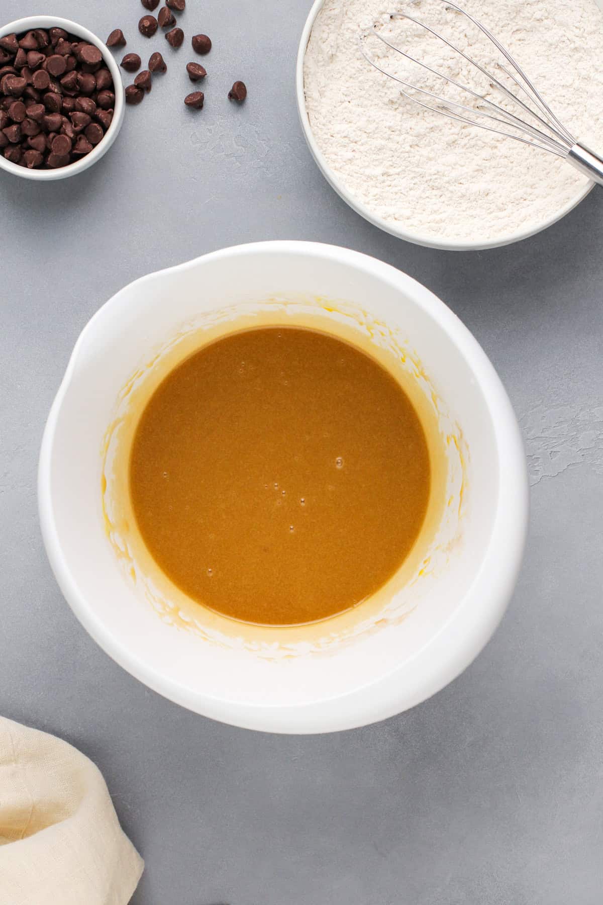 Wet ingredients for cookie bars in a white bowl.