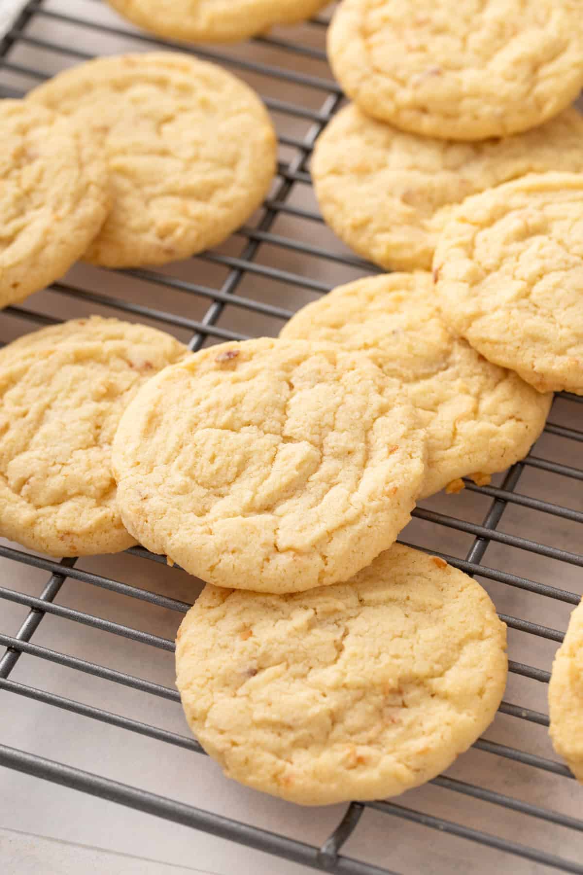 Coconut sugar cookies arranged on a wire cooling rack.