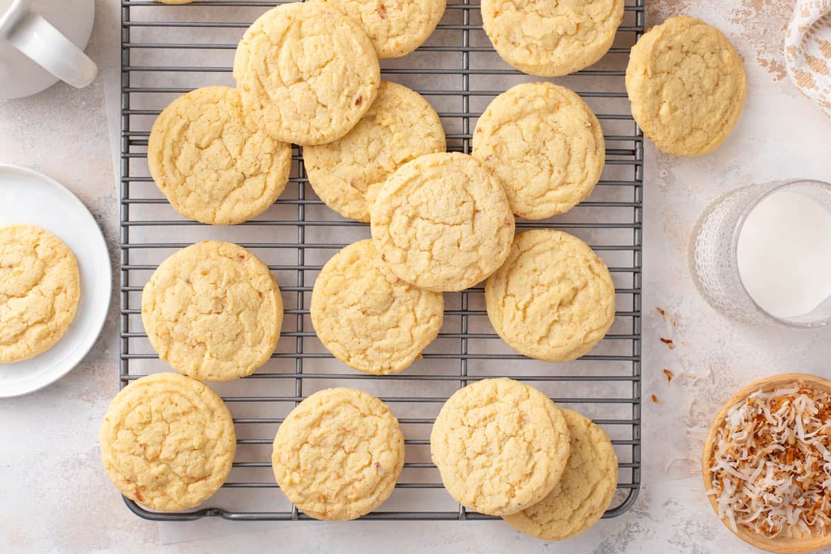 Overhead view of coconut sugar cookies cooling on a wire rack.