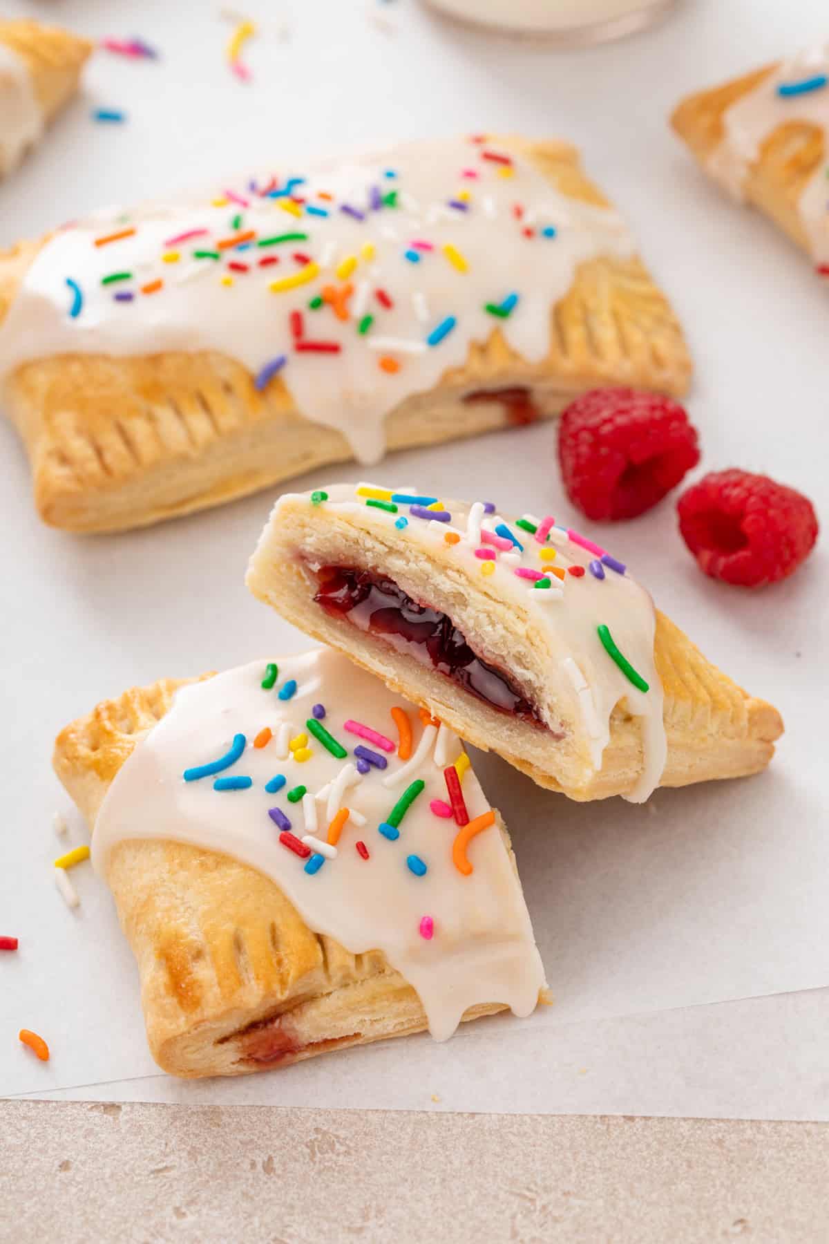 Homemade pop tart cut in half to show the raspberry jam filling.