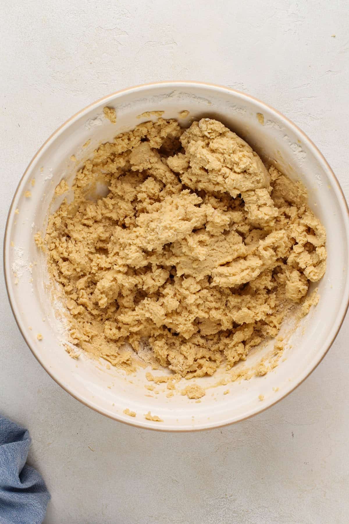 Cookie dough base for heath bar cookies in a ceramic mixing bowl.