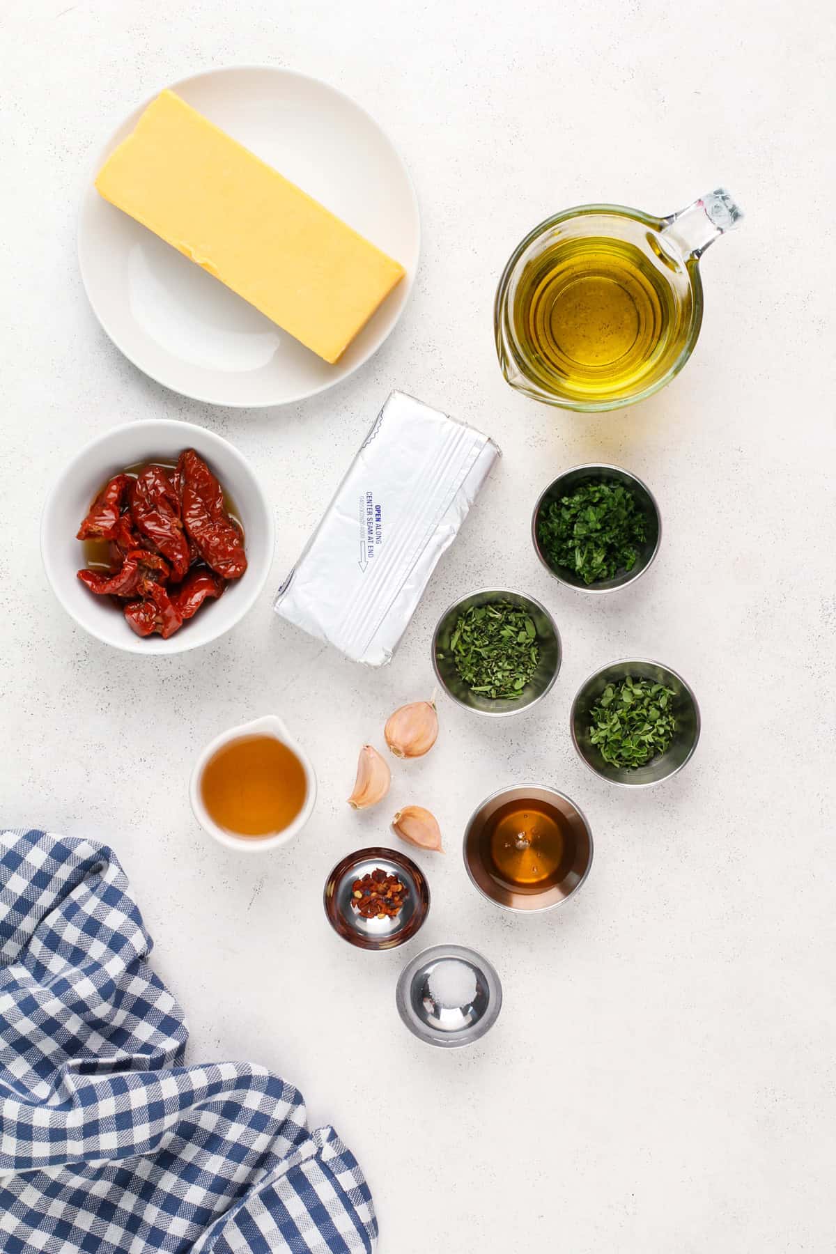 Ingredients for marinated cheese arranged on a countertop.