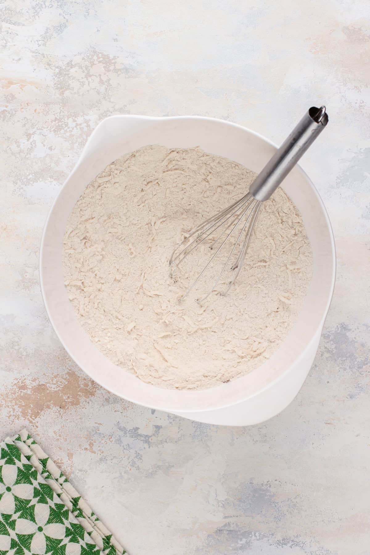 Dry ingredients whisked together in a white bowl.