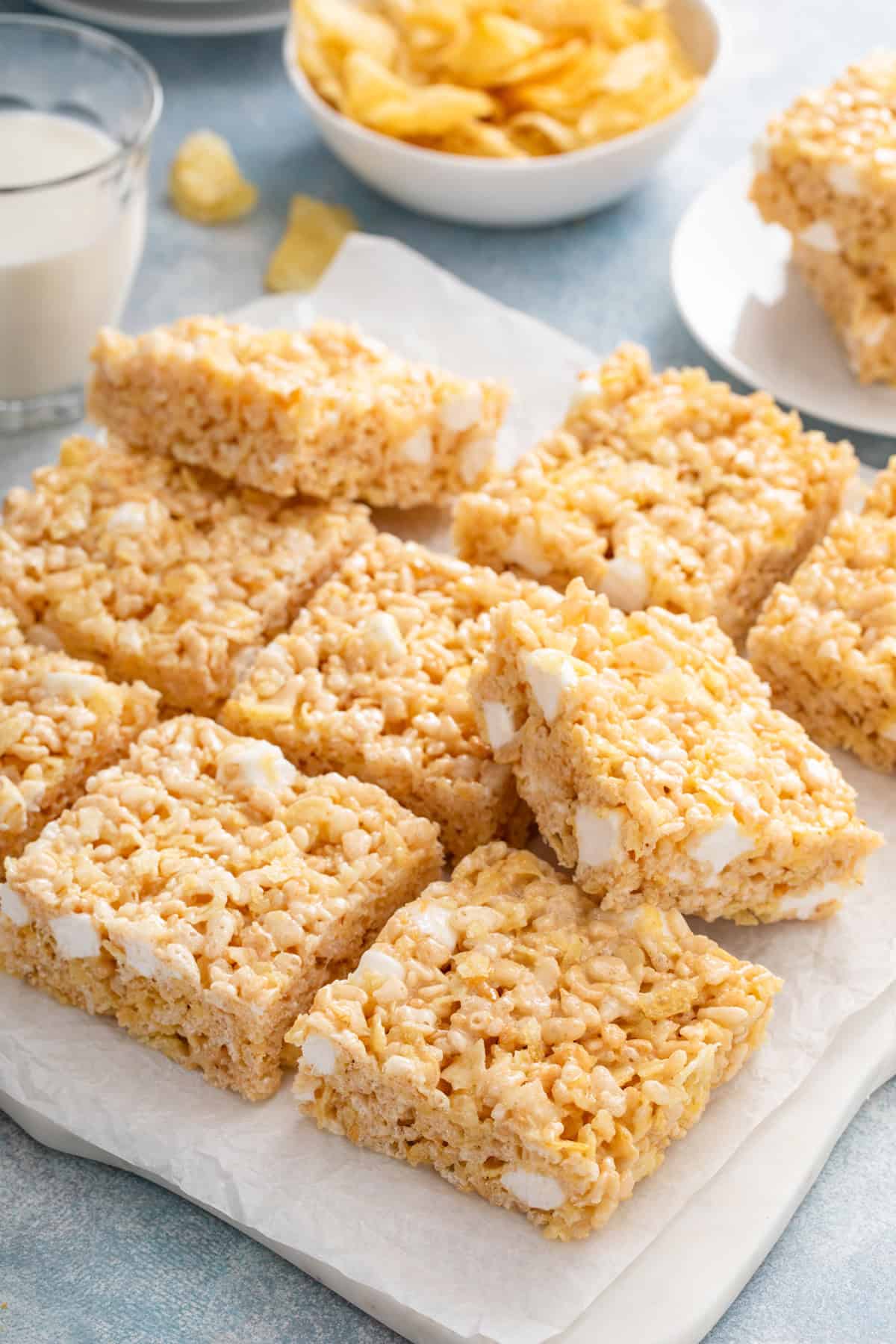 Sliced potato chip rice krispie treats on a piece of parchment paper on a platter.